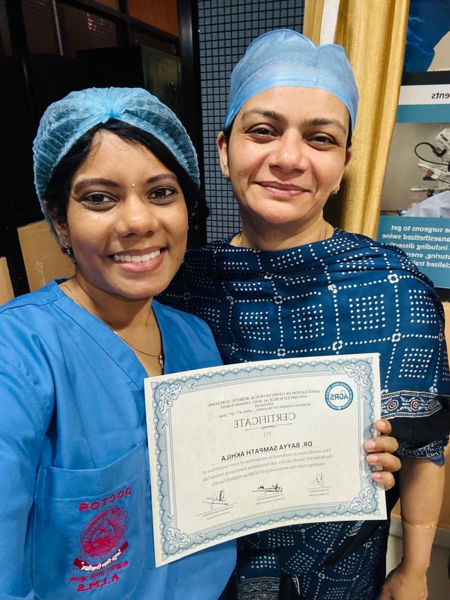 Dr. Mariam Anjum with colleague holding AGRS certificate in scrubs